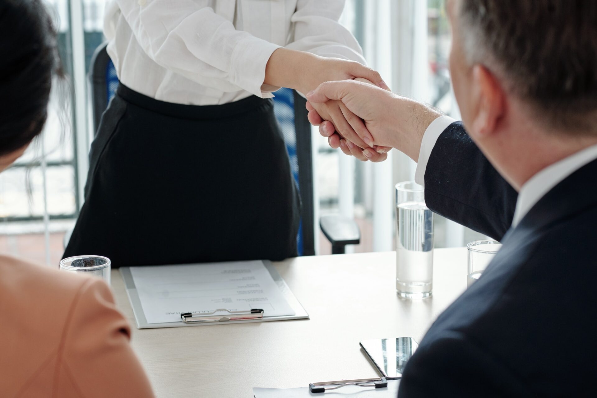 Applicant shaking hands of HR managers